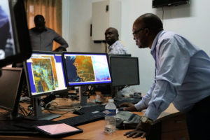 A man observing some forecasts on a computer